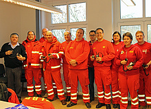 Rainer Mahn (li.) mit Einsatzkräften der DLRG im Schulungsraum des OV Lübeck
